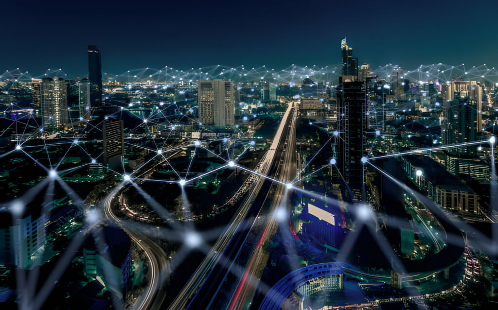 Image depicting an aerial view of a cityscape overlaid with mesh lines representing a mesh network infrastructure. The mesh lines connect various points within the city, illustrating the interconnected nature of the network.